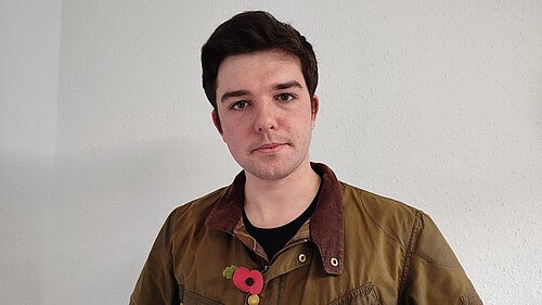 Alex Wagner wearing a poppy in Normandy